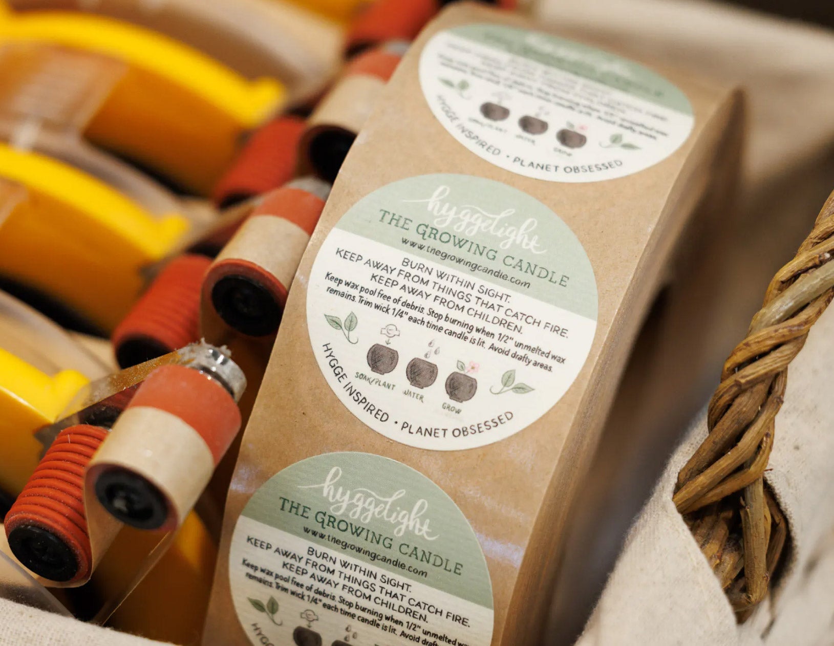Packaged candle with labels on a textured surface
