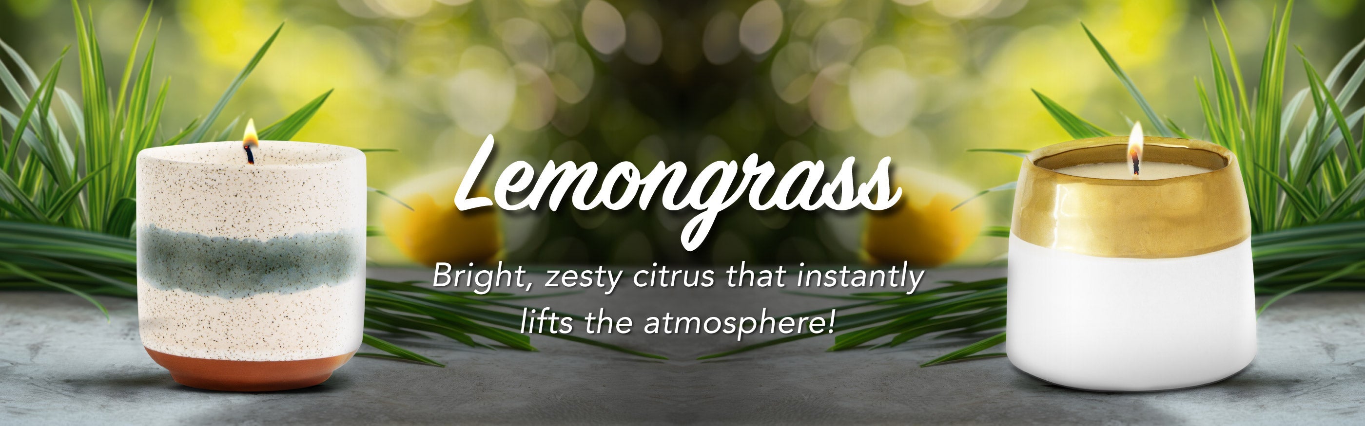 Two lemongrass-scented candles with greenery in the background