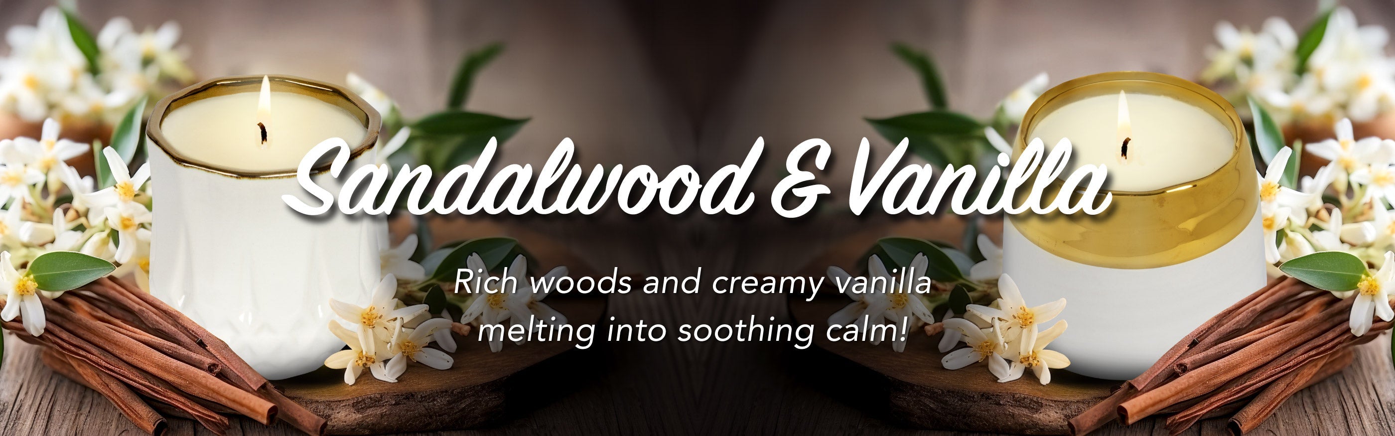 Two sandalwood and vanilla candles on a wooden surface with flowers and cinnamon sticks.